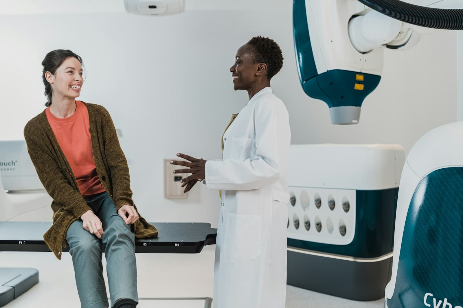 A clinician and patient in conversation in a bright treatment room