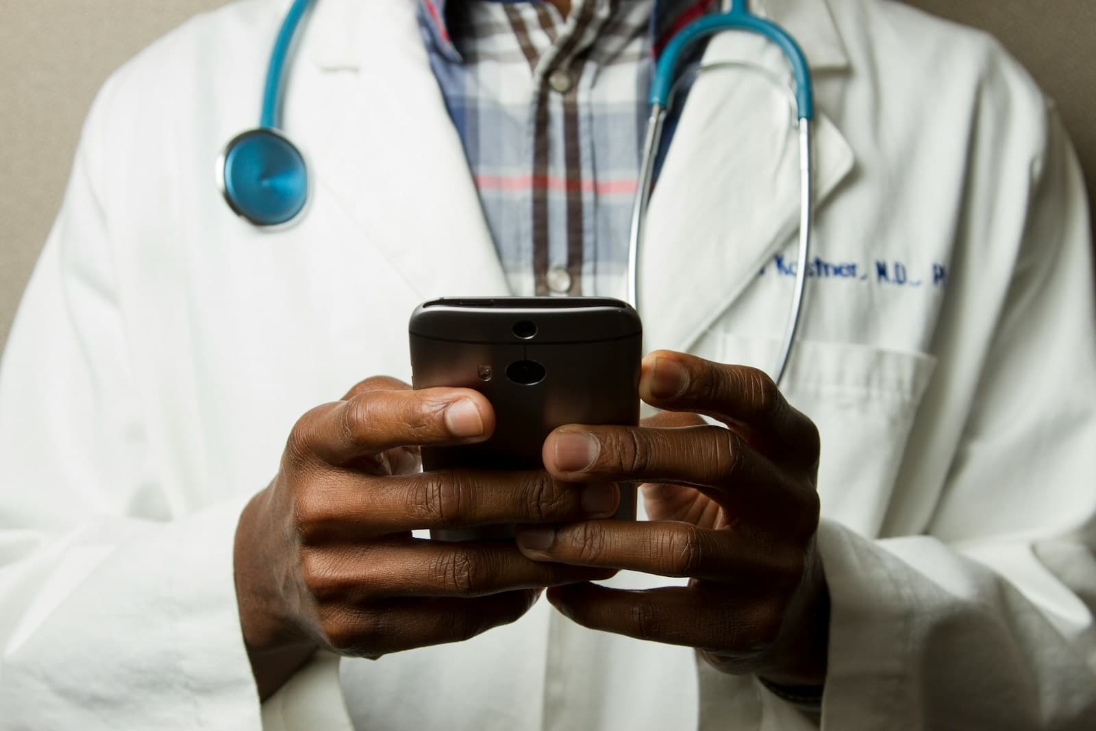 A clinician using a mobile phone between appointments
