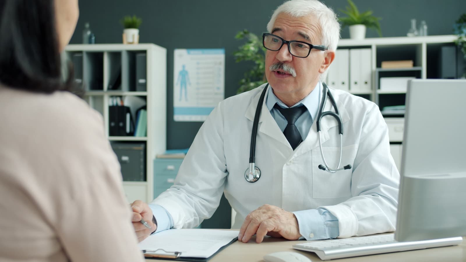 A clinician discussing results with a patient in a bright clinic