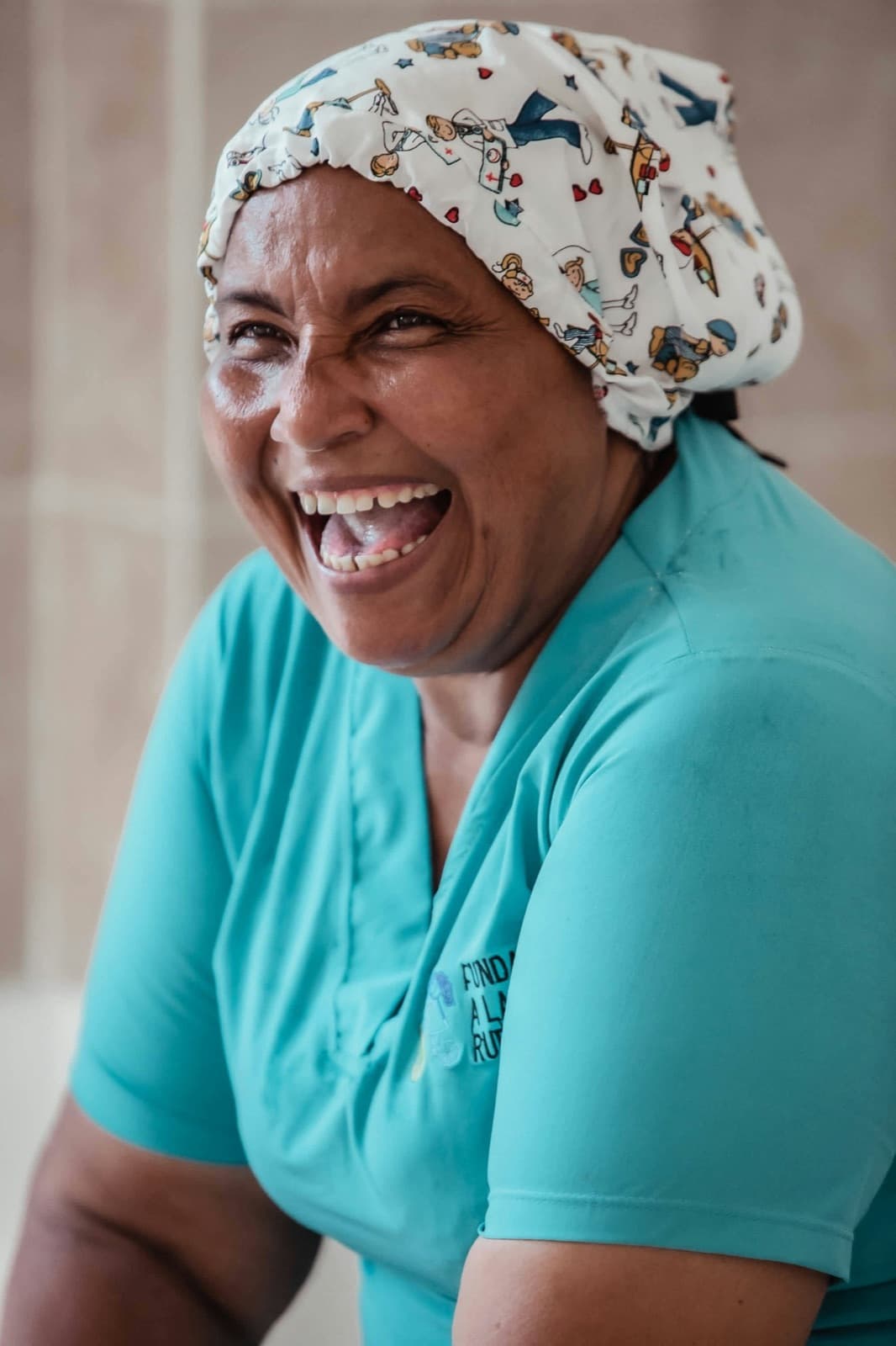 A smiling healthcare worker in scrubs